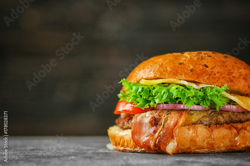 Tasty beef burger on table