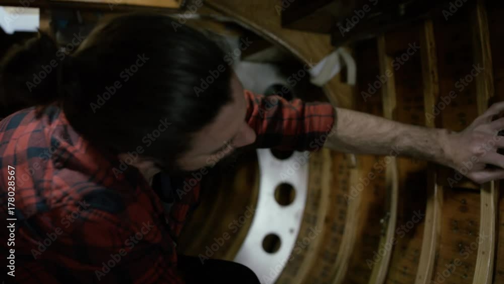 Worker in a boatyard, working on construction on the interior of sailing boat Worker in a boatyard, working on construction on the interior of sailing boat