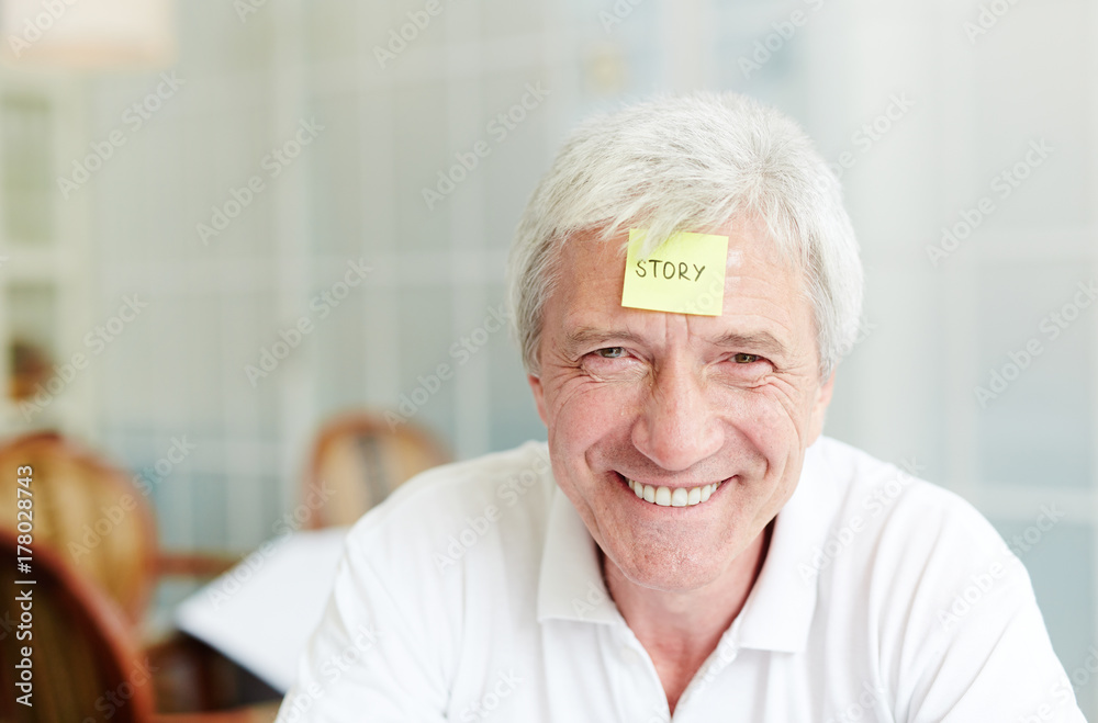 Grey-haired man with notepaper on his forehead should explain or guess the word Grey-haired man with notepaper on his forehead should explain or guess the word