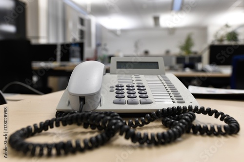 Old used business telephone in an empty office