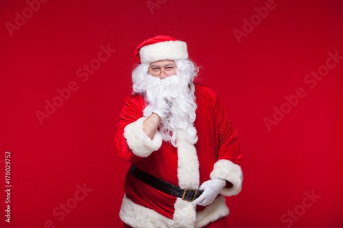 Santa Claus is dancing Isolated on red background.