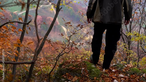 Man watching from high rocks autumn landscape - (4K) photo