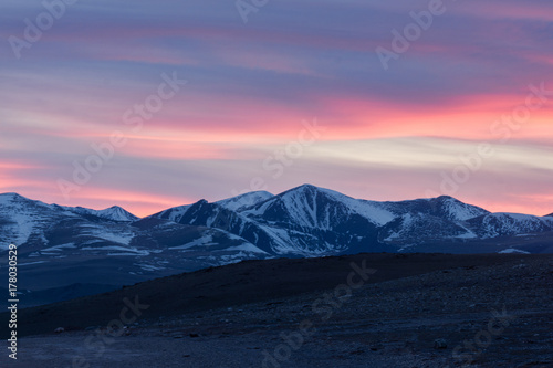 picturesque landscape of snow-covered mountains at sunrise 