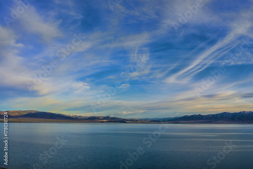 sky with huge grey clouds over sea surface at sunset   