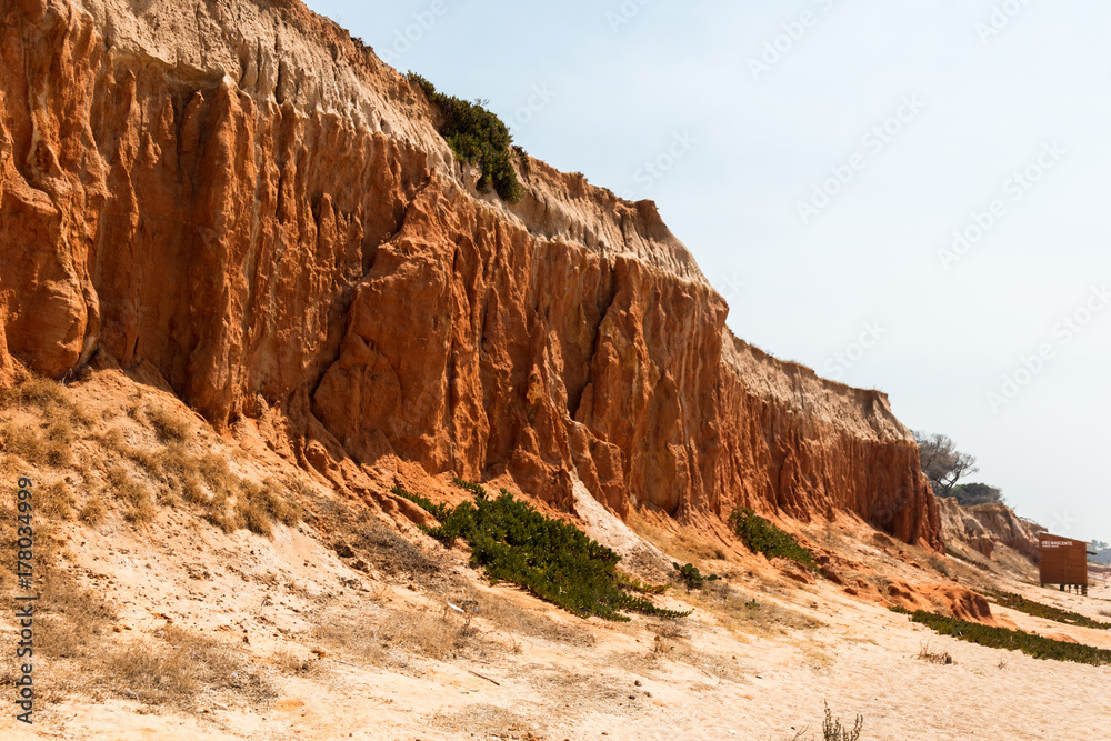 Red clay cliffs next to beach