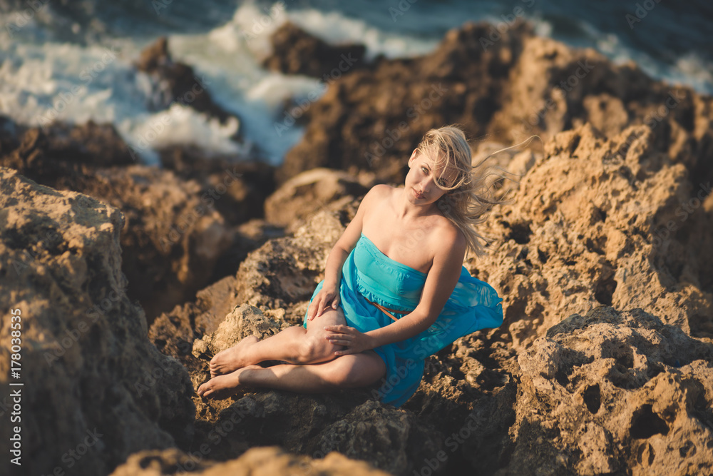 Seductive blond lady woman with sexy naked legs shoulders and arms