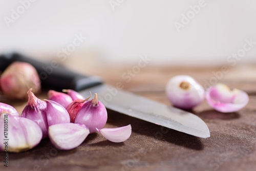 Slice shallots and knife on wooden background for cooking,spice an herb,food ingredient
