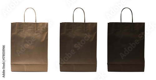 Three paper bags with different shades of brown craft paper colors, isolated on white background, including clipping path