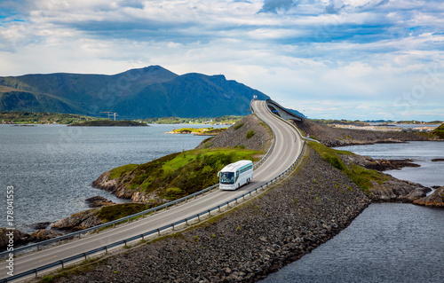 Tourist bus traveling on the road in Norway photo