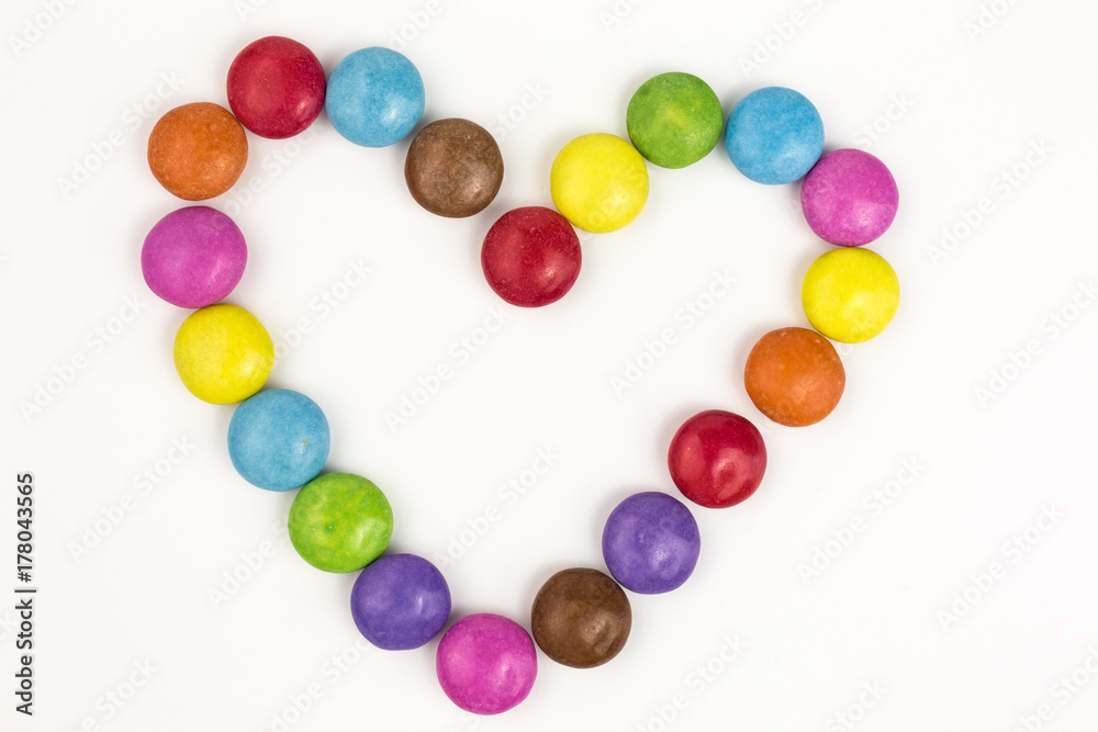 rainbow colored sugar coated candies in heart shape