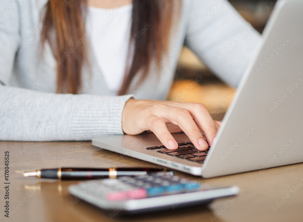 Young woman working on her laptop in a coffee shop. Social networking technology concept. Young woman working on her laptop in a coffee shop. Social networking technology concept.