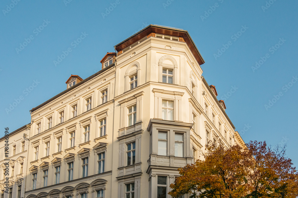residential corner building with autumn tree