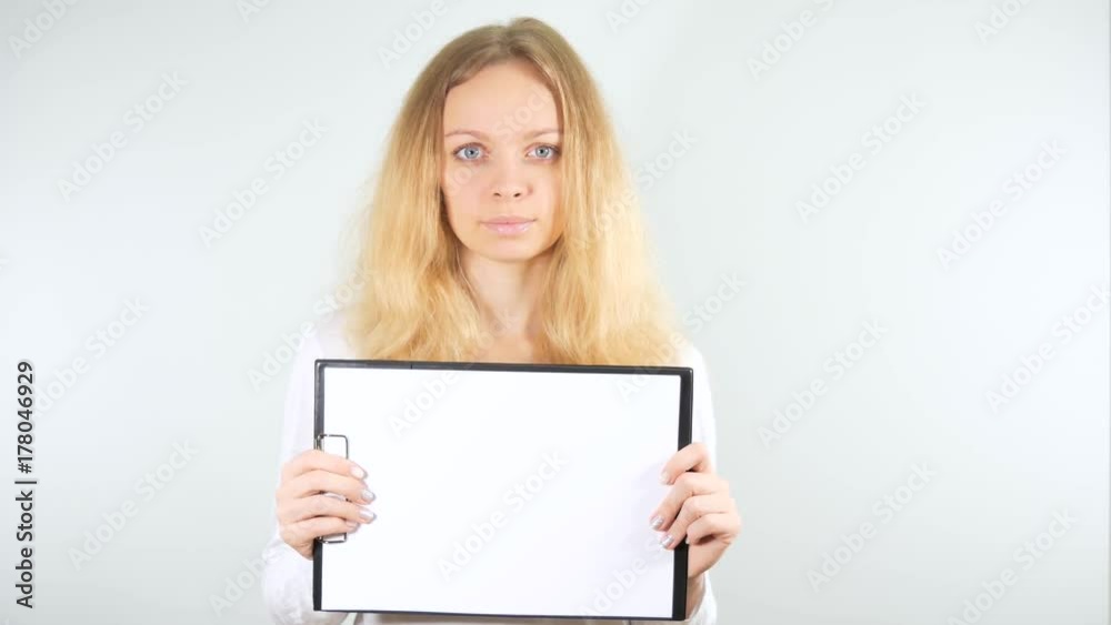 Girl posing with a blank sign. Isolated on a white background. Mockup Girl posing with a blank sign. Isolated on a white background. Mockup
