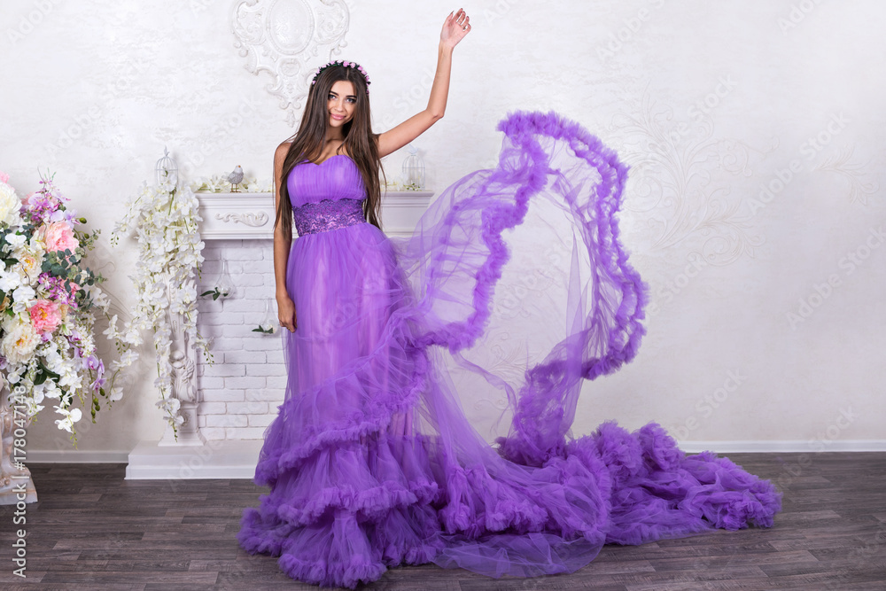 Portrait of a beautiful woman with a raised hand in a flowing dress Portrait of a beautiful woman with a raised hand in a flowing dress