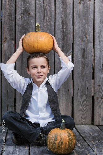 Halloween time, the boy plays with the pumpkin photo