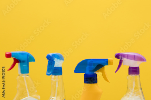 Cleaning spray bottle products on a bright yellow background