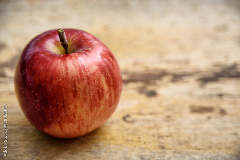 Red apple on rustic wooden background. Autumn fruit Red apple on rustic wooden background. Autumn fruit