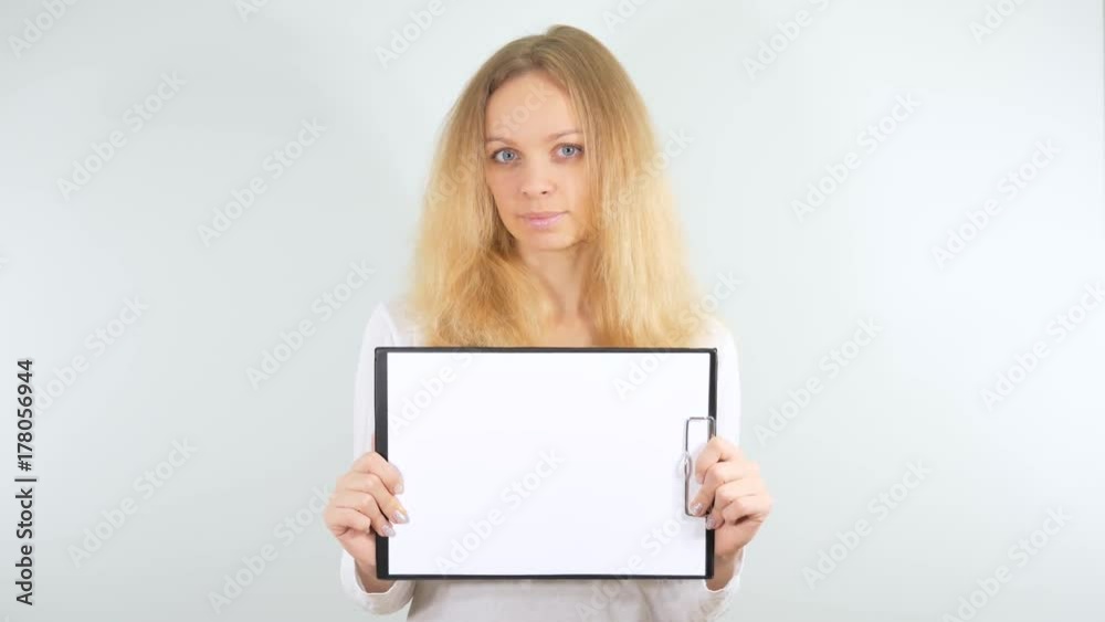 Girl posing with a blank sign. Isolated on a white background. Mockup Girl posing with a blank sign. Isolated on a white background. Mockup