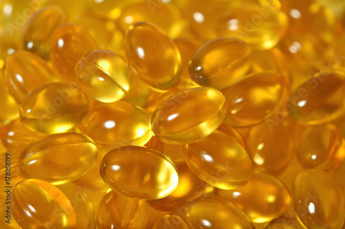 Omega-3 fish fat oil capsules as background texture