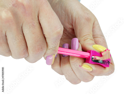 Hands with sharpener and pencil on an isolated background