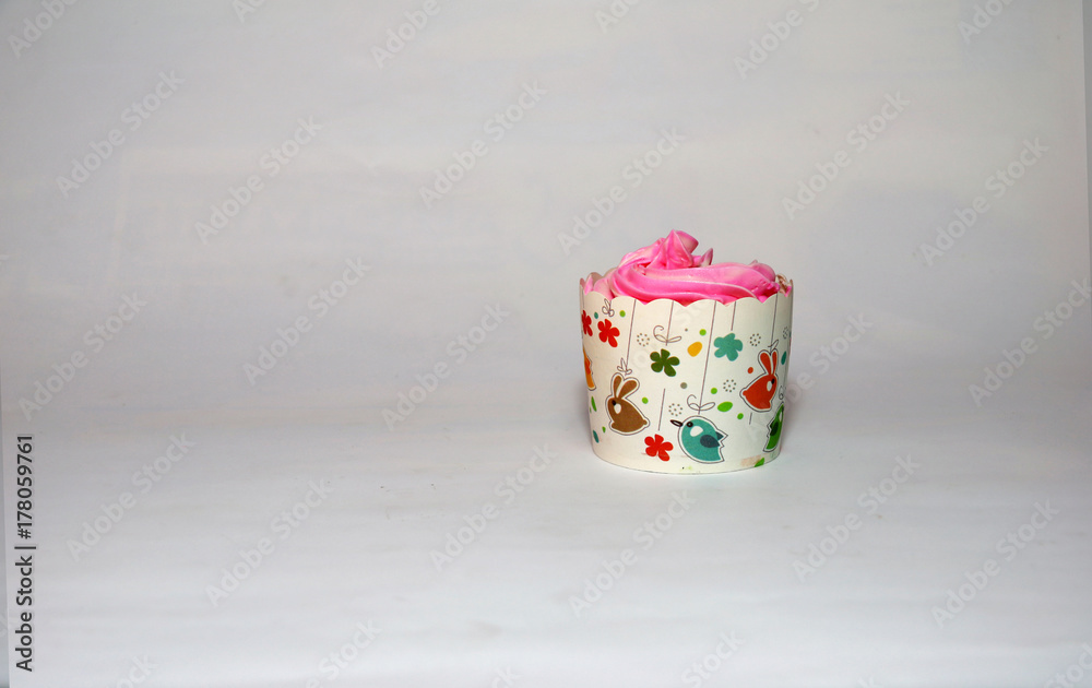 One cup cake on the white background. cupcake is a small cake baked in a cup-shaped container. One cup cake on the white background. cupcake is a small cake baked in a cup-shaped container.