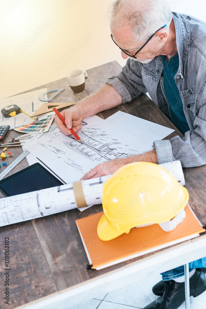 Architect working on plans, light effect Architect working on plans, light effect
