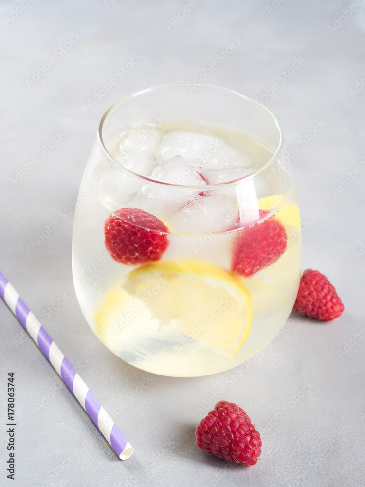 Cocktail with raspberries and lemon slices or infused detox water Cocktail with raspberries and lemon slices or infused detox water