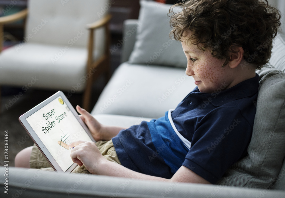 Young Caucasian boy using digital tablet Young Caucasian boy using digital tablet