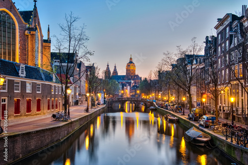 Amsterdam city at night with the canal in Amsterdam city, Netherlands