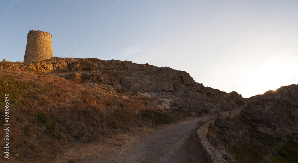 Corsica, 30/08/2017: tramonto sulla torre genovese costruita nel XV secolo in cima all'Isola della Pietra, il promontorio disabitato di Isola Rossa, famosa città dell'Alta Corsica Corsica, 30/08/2017: tramonto sulla torre genovese costruita nel XV secolo in cima all'Isola della Pietra, il promontorio disabitato di Isola Rossa, famosa città dell'Alta Corsica
