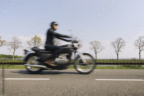 Blurry image of a rider or a motorcyclist on a classic motor