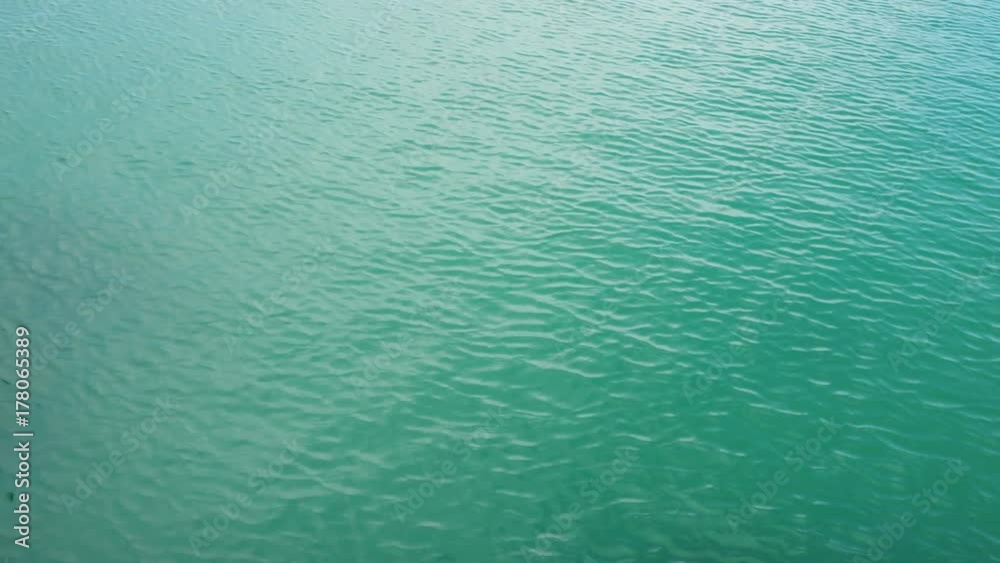 The surface of the turquoise sea is blown by the wind. The surface of the turquoise sea is blown by the wind.