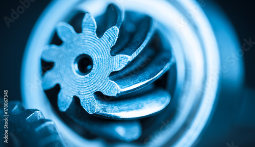 Beautiful close-up of steel gearwheel. Abstract industrial background with cogwheels in blue color. photo