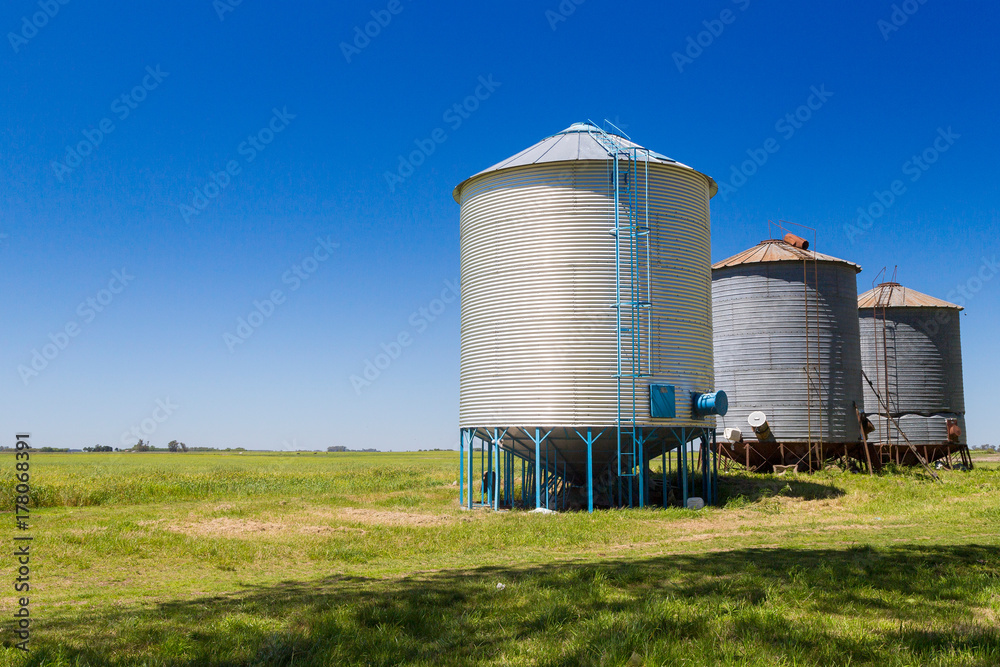 Three farm grain silos for agriculture. New and old silos. Three farm grain silos for agriculture. New and old silos.
