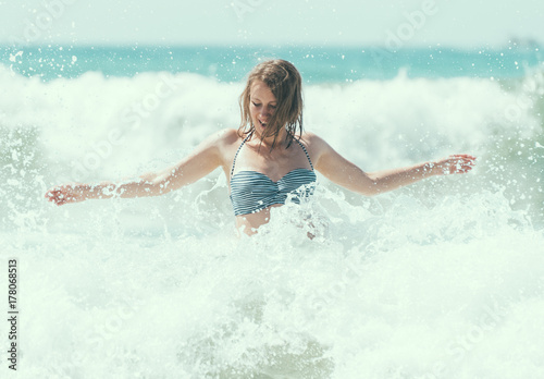 Happy woman having fun in the sea.