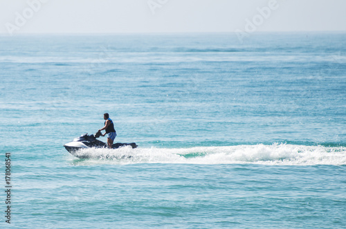 Man riding on water scooter in the sea.