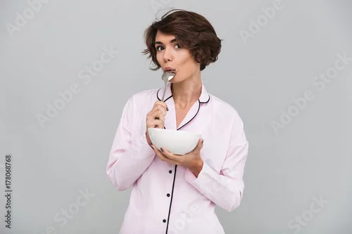 Naklejka Portrait of an attractive young girl in pajamas