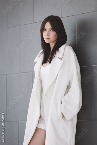A portrait of a beautiful woman in a white winter coat