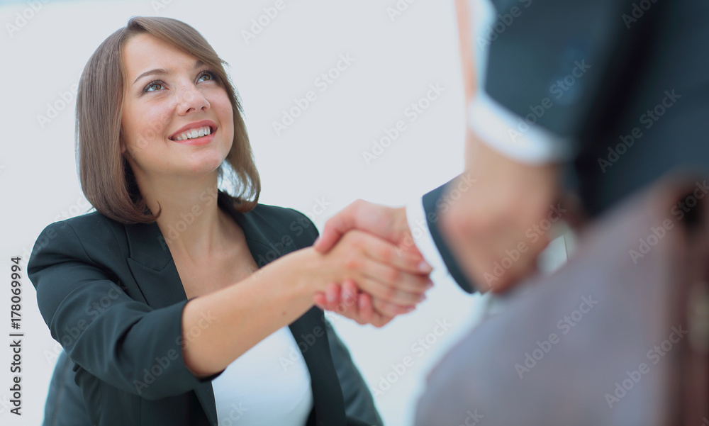 An attractive woman and man business team shaking hands at offic