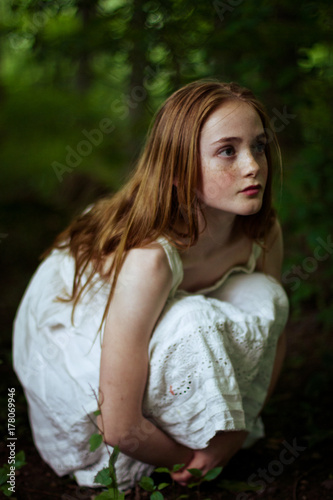 Little girl crouching