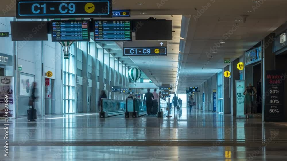 TEL AVIV, ISRAEL- MARCH 15, 2017: Timelapse shot of people traffic in the hall with gate pointers and travelator. Inside Ben Gurion International Airport