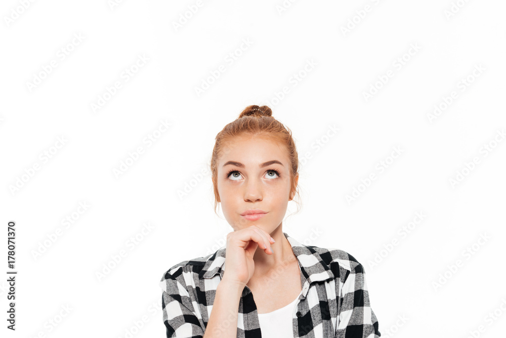 Close up image of pensive ginger woman holding chin Close up image of pensive ginger woman holding chin