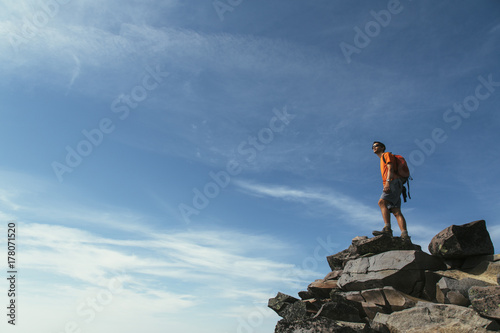 Male hiker standing on mountain summit