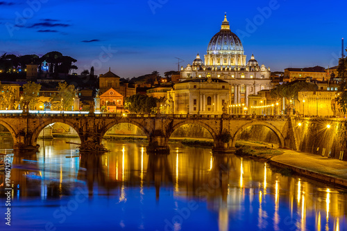 Night view of Basilica St Peter, bridge Sant Angelo and river Tiber in Rome. Italy