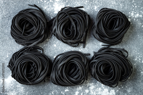 Fényképezés Detox charcoal or black squid ink fettuccine on grey background