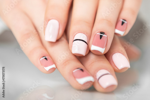 Beautiful female hands with a fashionable manicure. Geometric design of nails. Photo closeup photo
