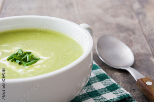 zucchini soup in bowl on wooden table