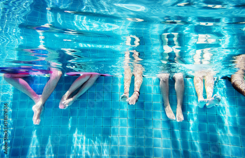 Group of people legs underwater photo