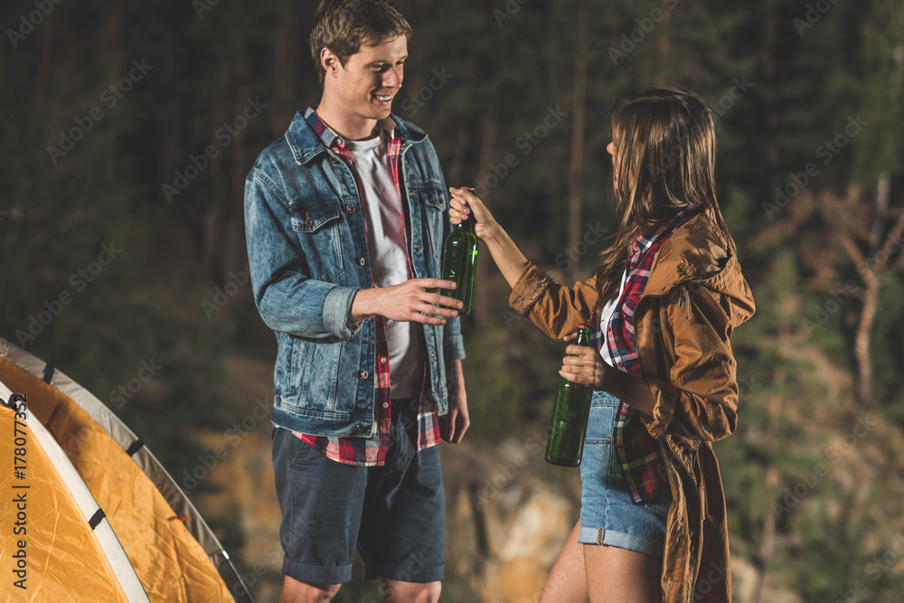 couple sharing beer in hiking trip
