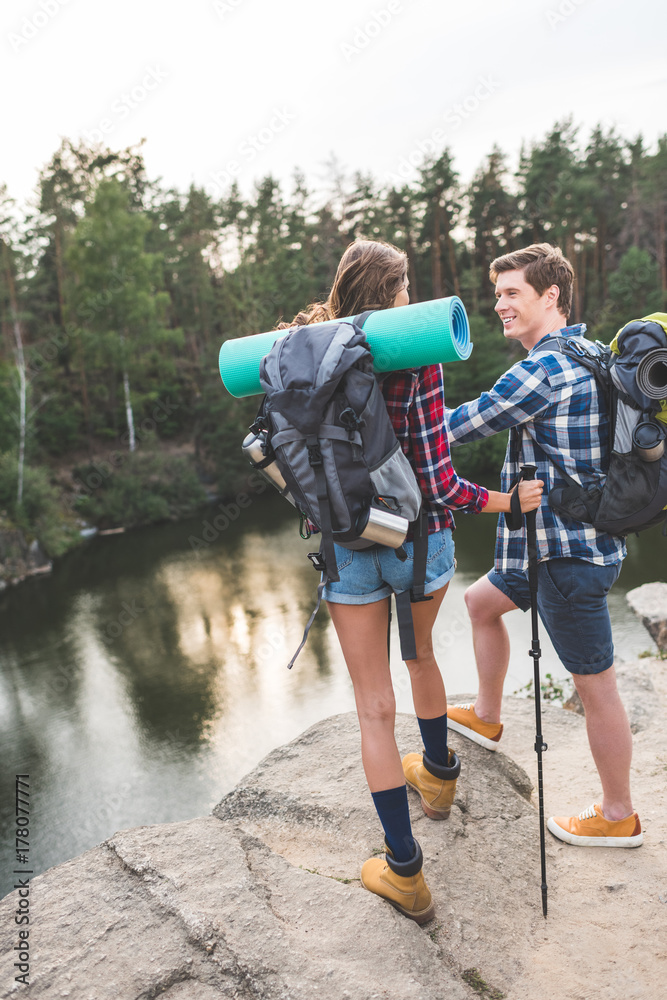 couple with backpacks having hiking trip